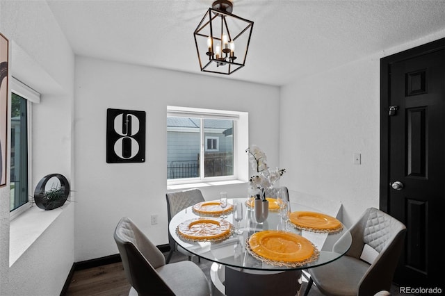 3275 W Hawthorne Pl, Denver, CO 80221 - dining room featuring wood finished floors, a chandelier, and a textured ceiling
