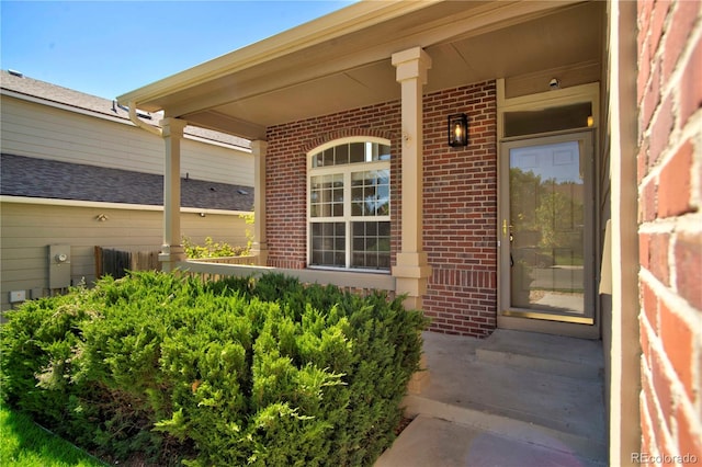 view of exterior entry with covered porch