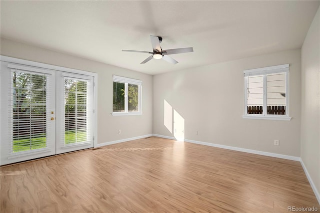 spare room featuring french doors, ceiling fan, and light wood-type flooring