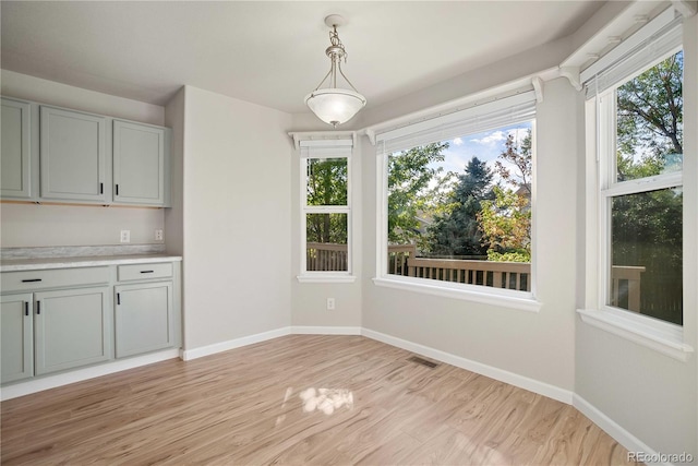 unfurnished dining area with light wood-type flooring