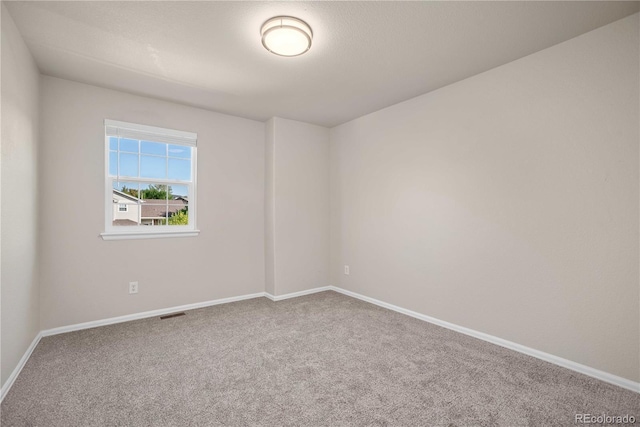 unfurnished room with carpet flooring