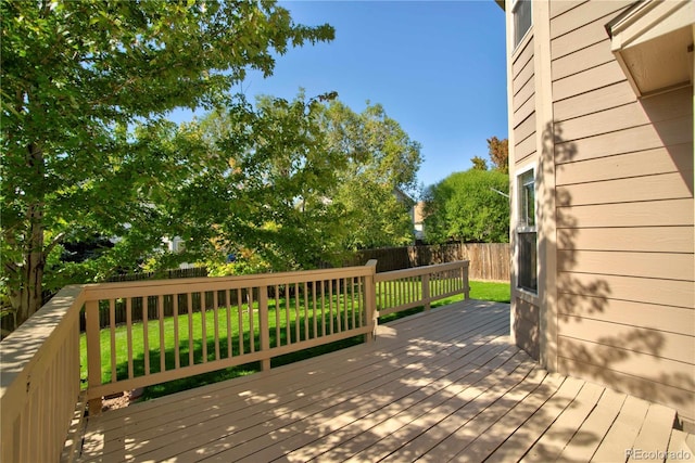 wooden deck with a lawn