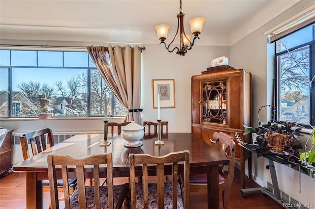 dining space featuring a chandelier and wood finished floors