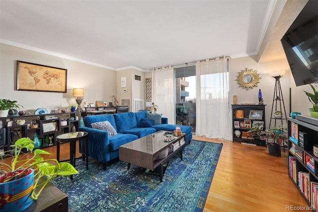 living room featuring wood-type flooring and ornamental molding