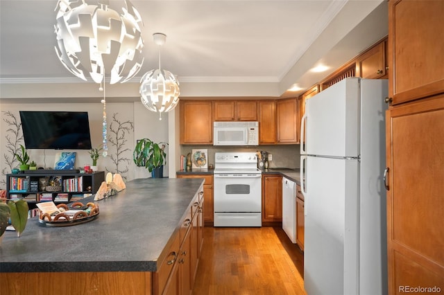 kitchen featuring crown molding, light wood-type flooring, pendant lighting, and white appliances