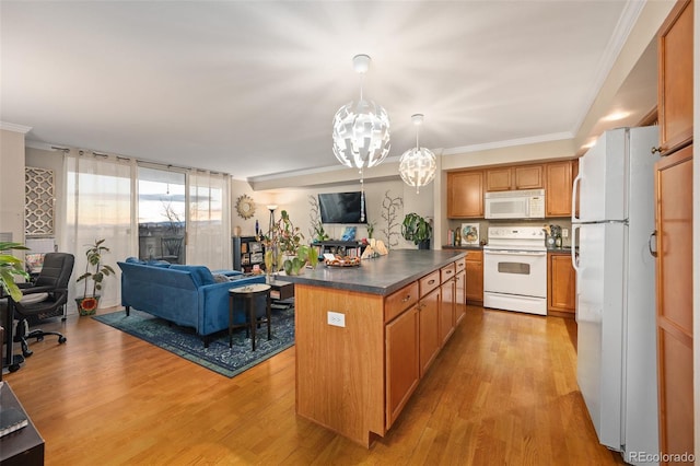 kitchen featuring white appliances, a center island, light hardwood / wood-style floors, and hanging light fixtures