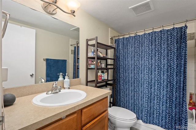 bathroom with vanity, toilet, and curtained shower