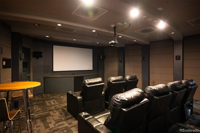 cinema room featuring dark colored carpet