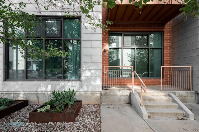 doorway to property with brick siding
