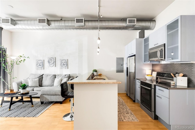 kitchen featuring visible vents, light wood-type flooring, and stainless steel appliances