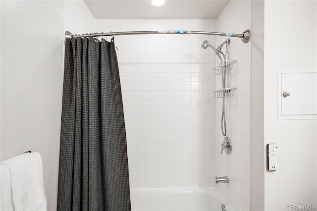 bathroom with shower / bathtub combination with curtain