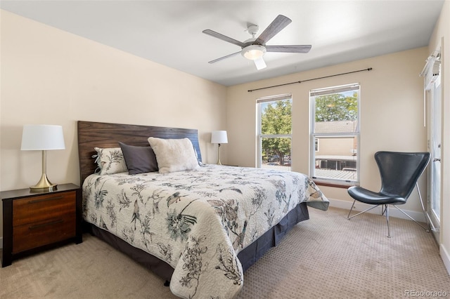 bedroom featuring ceiling fan and light carpet