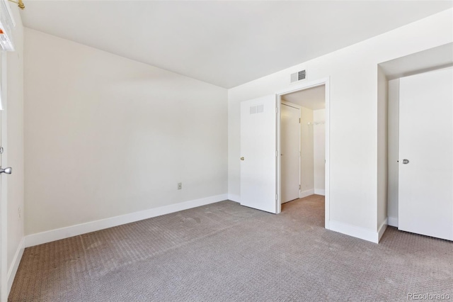 unfurnished bedroom featuring light carpet