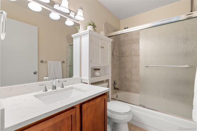 full bathroom featuring vanity, enclosed tub / shower combo, and toilet