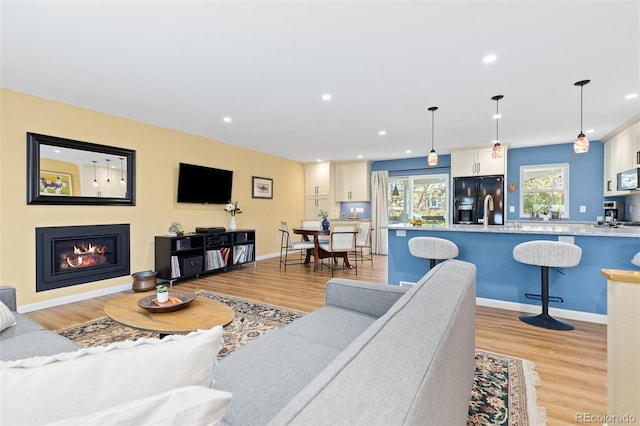 15000 W 29th Ave, Golden, CO 80401 - living area featuring light wood-type flooring, recessed lighting, a glass covered fireplace, and baseboards