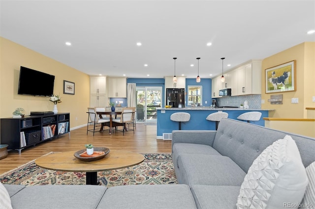 15000 W 29th Ave, Golden, CO 80401 - living room featuring light wood finished floors, recessed lighting, and baseboards