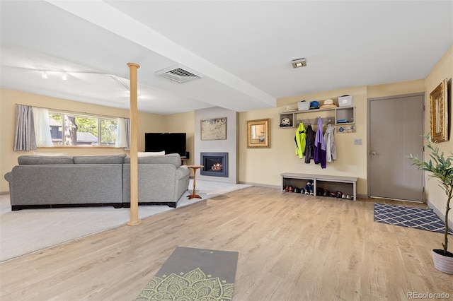 15000 W 29th Ave, Golden, CO 80401 - living room with wood finished floors, a lit fireplace, and baseboards