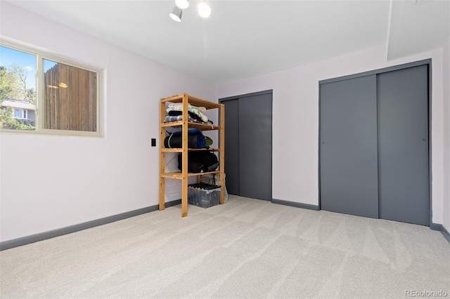 15000 W 29th Ave, Golden, CO 80401 - unfurnished bedroom with carpet flooring, two closets, and baseboards