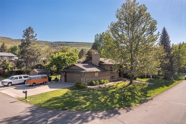 15000 W 29th Ave, Golden, CO 80401 - view of front of property featuring driveway, a front yard, a chimney, and a garage