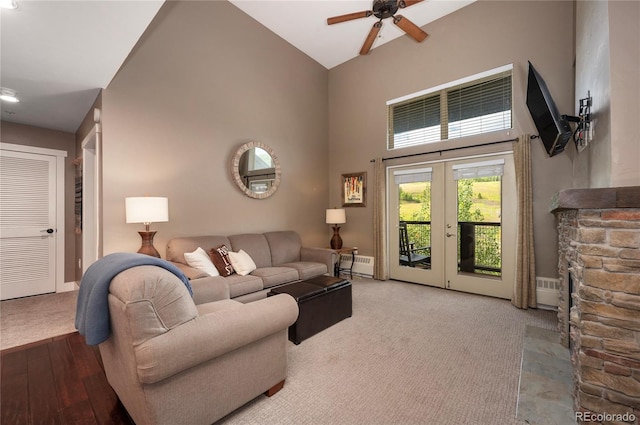 living room with french doors, a baseboard radiator, carpet floors, high vaulted ceiling, and ceiling fan