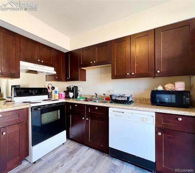 kitchen with electric range oven, sink, white dishwasher, and light wood-type flooring