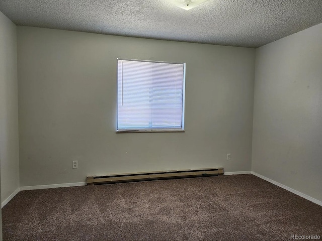 empty room with carpet floors, a textured ceiling, and a baseboard heating unit