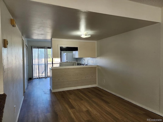 kitchen with white fridge, sink, and dark wood-type flooring