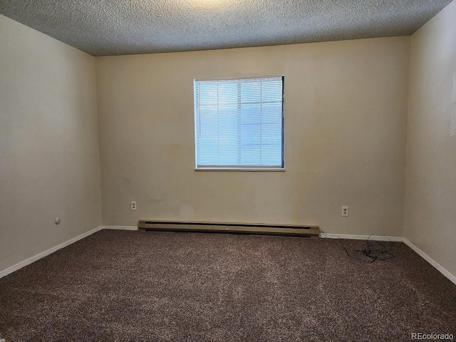 carpeted empty room featuring a baseboard heating unit and a textured ceiling