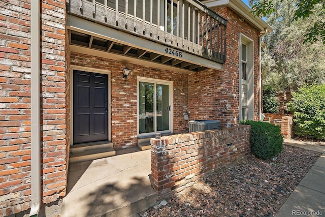 4246 S Granby St Unit B, Aurora, CO 80014 - view of exterior entry featuring a balcony and brick siding