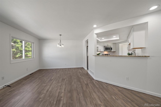 4246 S Granby St Unit B, Aurora, CO 80014 - unfurnished living room featuring dark wood-style floors, recessed lighting, and a chandelier
