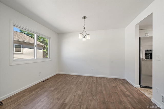 4246 S Granby St Unit B, Aurora, CO 80014 - unfurnished dining area featuring wood finished floors and a chandelier