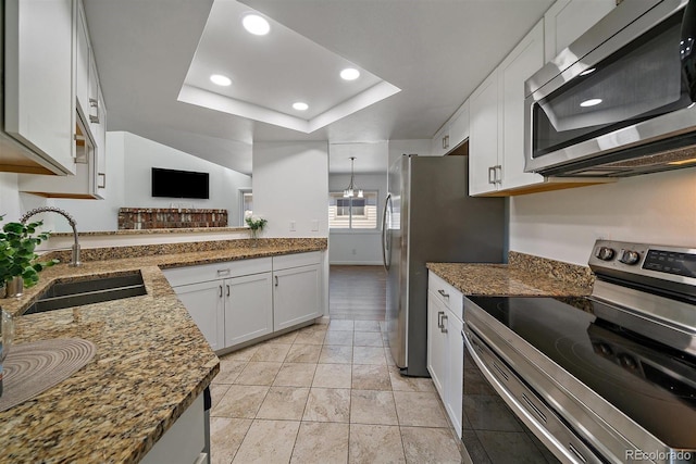 4246 S Granby St Unit B, Aurora, CO 80014 - kitchen with appliances with stainless steel finishes, recessed lighting, a tray ceiling, white cabinets, and dark stone countertops