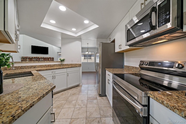 4246 S Granby St Unit B, Aurora, CO 80014 - kitchen featuring appliances with stainless steel finishes, white cabinetry, recessed lighting, a raised ceiling, and stone counters
