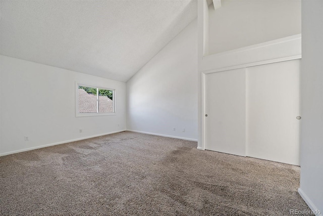4246 S Granby St Unit B, Aurora, CO 80014 - unfurnished bedroom featuring carpet floors, high vaulted ceiling, a closet, and a textured ceiling