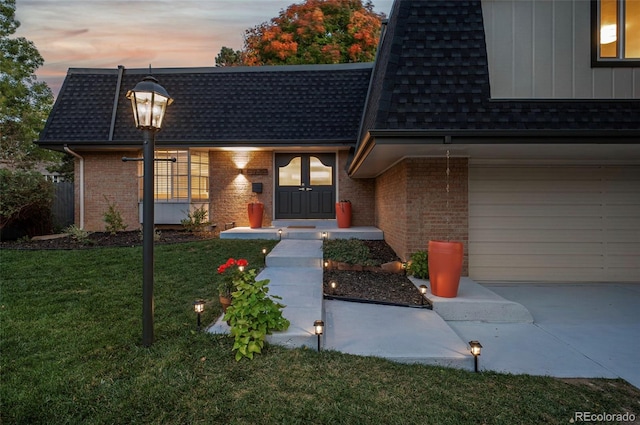 view of front facade with a garage and a lawn