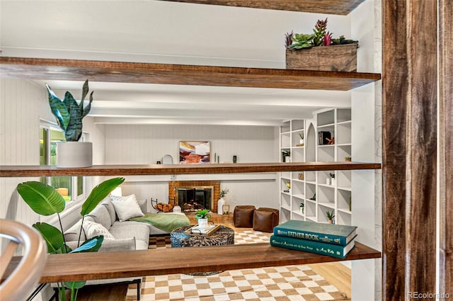 room details featuring a baseboard heating unit, a fireplace, and hardwood / wood-style flooring