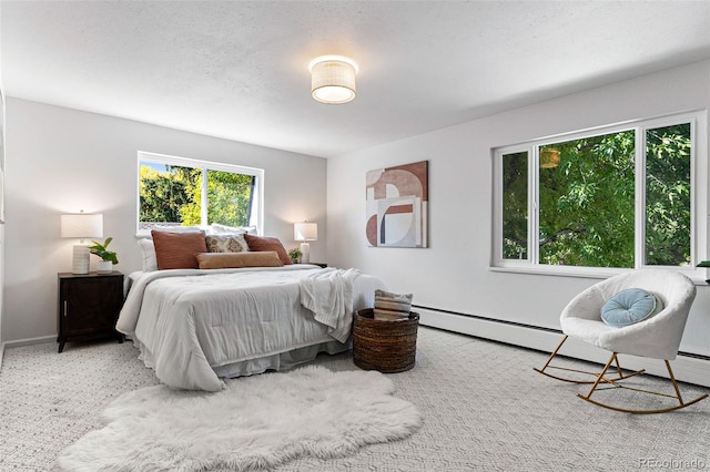 carpeted bedroom featuring a textured ceiling and a baseboard heating unit