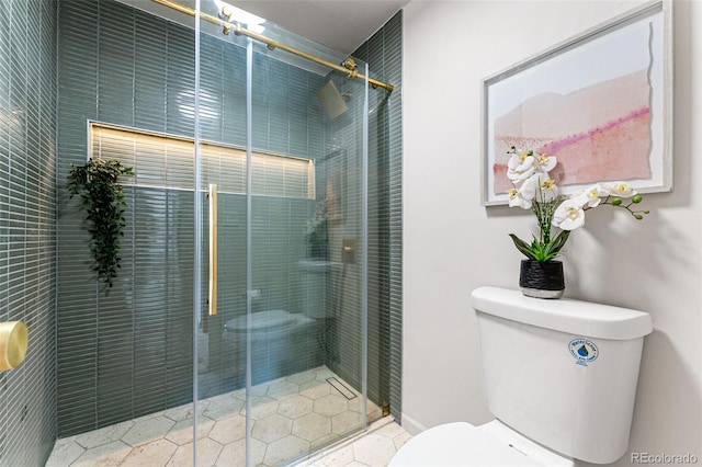 bathroom with a shower with door and toilet