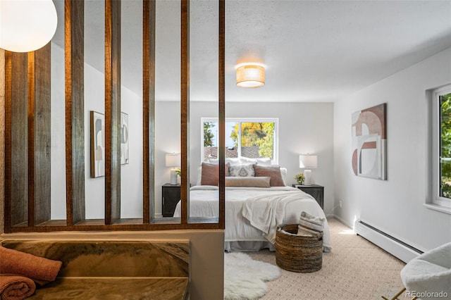 carpeted bedroom featuring multiple windows and baseboard heating