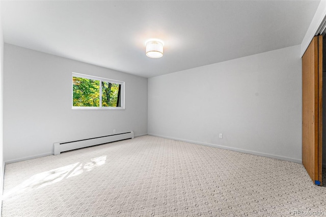 carpeted spare room with a baseboard radiator