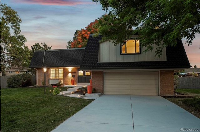 view of front of property with a yard and a garage