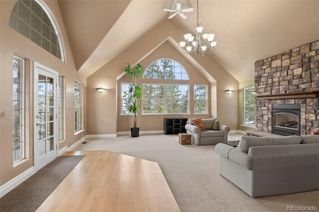 living room with high vaulted ceiling, carpet, a fireplace, and an inviting chandelier