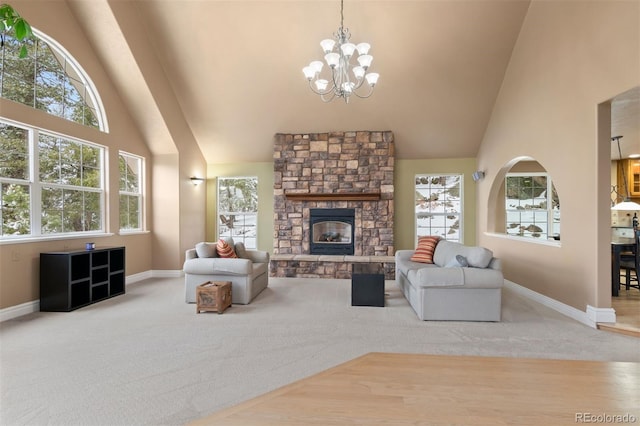 6530 Ridgeview Dr, Morrison, CO 80465 - carpeted living area with a chandelier, high vaulted ceiling, baseboards, and a stone fireplace
