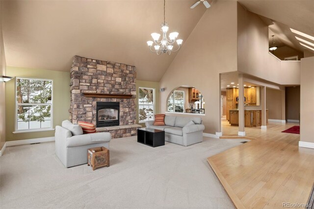 6530 Ridgeview Dr, Morrison, CO 80465 - living area with baseboards, a fireplace, a chandelier, high vaulted ceiling, and carpet floors