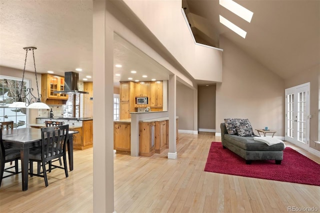 6530 Ridgeview Dr, Morrison, CO 80465 - living room with light wood-style floors, high vaulted ceiling, baseboards, recessed lighting, and a skylight