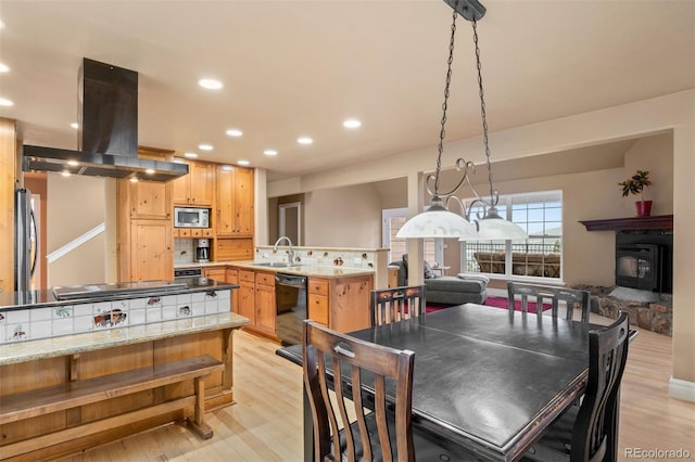 6530 Ridgeview Dr, Morrison, CO 80465 - dining area featuring light wood-style flooring, recessed lighting, and a wood stove