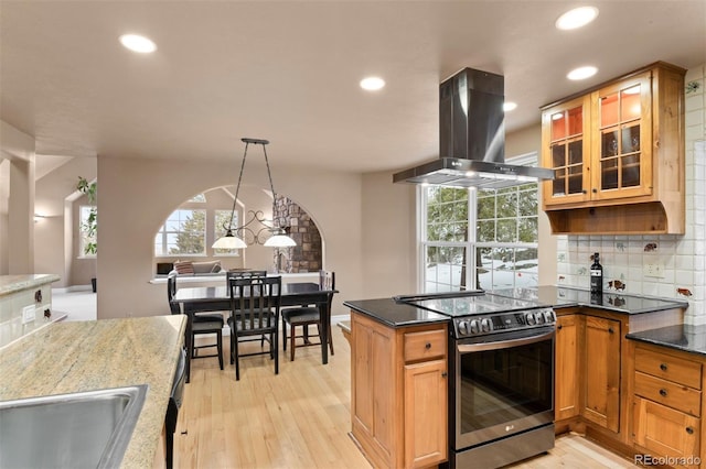 6530 Ridgeview Dr, Morrison, CO 80465 - kitchen with stainless steel range with electric cooktop, island exhaust hood, light wood finished floors, recessed lighting, and plenty of natural light