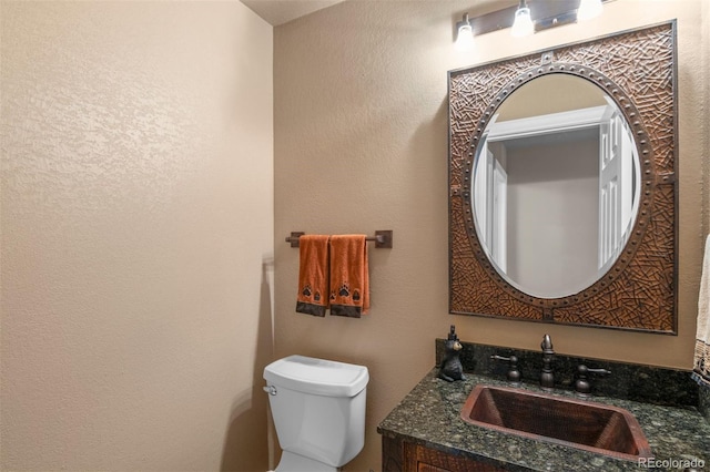 6530 Ridgeview Dr, Morrison, CO 80465 - half bath featuring toilet, vanity, and a textured wall