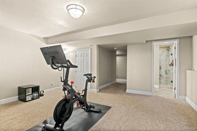 6530 Ridgeview Dr, Morrison, CO 80465 - exercise room with carpet floors, a textured ceiling, and baseboards