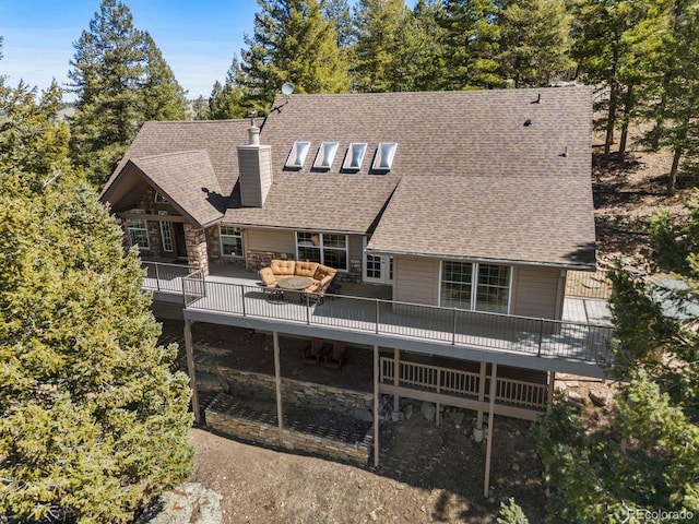 6530 Ridgeview Dr, Morrison, CO 80465 - back of house featuring outdoor lounge area, a chimney, a shingled roof, and a deck
